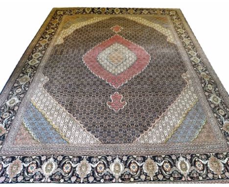 TABRIZ CARPET, 388cm x 296cm, Persian Mahi design of ivory and rose pendant medallion on sapphire field, corresponding bands 