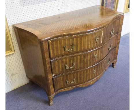 SERPENTINE COMMODE, 18th century Continental, fruitwood parquetry fitted with three long drawers, all-over crossbanded with g
