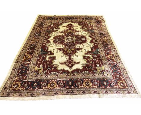 FINE PERSIAN HERIZ CARPET, 312cm x 235cm, pendant medallion on an ivory field within corresponding spandrels and borders.