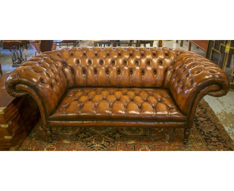 CHESTERFIELD SOFA, traditional hand finished button upholstered leaf brown leather, with deeply curved back and arms, and tur