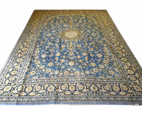 KASHAN CARPET, 403cm x 300cm, azure field and sapphire border with central medallion and all over scrolling palmettes and vin