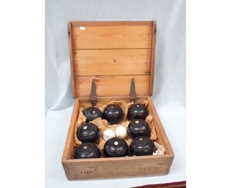 A VINTAGE PINE-CASE LAWN BOWLING SET ; THE 'BUNGALOW' the ceramic jacks marked 'Taylor-Rolph, London' (some woods with number
