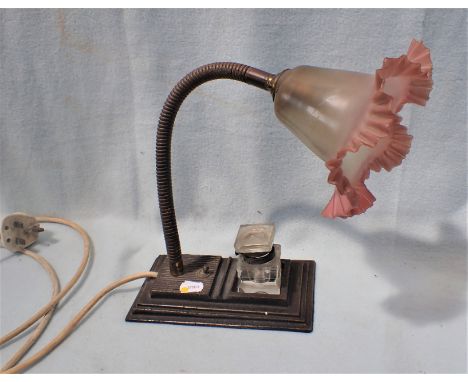 AN EARLY 20TH CENTURY ADJUSTABLE DESK LAMP by 'Hawkins', the cast iron base with well for (replaced) inkwell, pen rests, and 