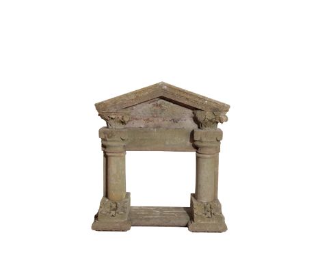 A CARVED SANDSTONE ARCHITECTURAL PORTAL previously used as a fireplace, probably early 19th century, with pediment and Ionic 