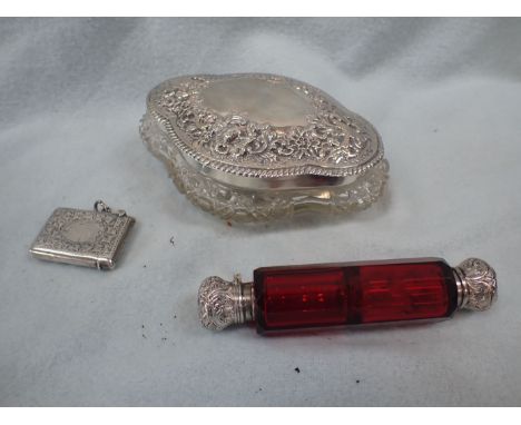 A WHITE METAL TOPPED DOUBLE-ENDED RUBY GLASS SCENT BOTTLE 12cm long, a silver lidded dressing table pot, and a silver vesta