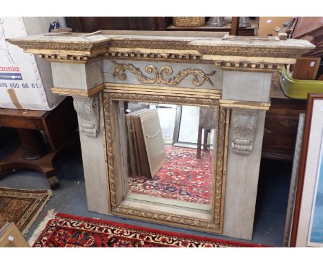 AN OVERMANTEL OR PIER MIRROR OF ARCHITECTURAL FORM painted and gilt, with deep overhanging cornice, and carved corbels 120cm 