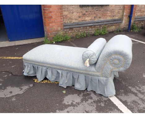 A VICTORIAN DAYBED, IN FIGURED BLUE UPHOLSTERY with tapered legs 185 cm long (leg detached,marks to cover)