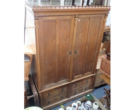 A 19TH CENTURY LIGHT OAK LINEN PRESS IN THE MANNER OF CHARLES BEVAN in gothic revival style, 214cm high x 140cm wide x 58cm d