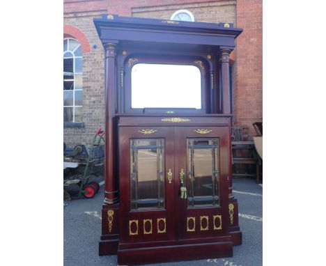 A FRENCH MAHOGANY BUFFET in the Empire style, the mirrored centre flanked by full height pillars 121cm wide