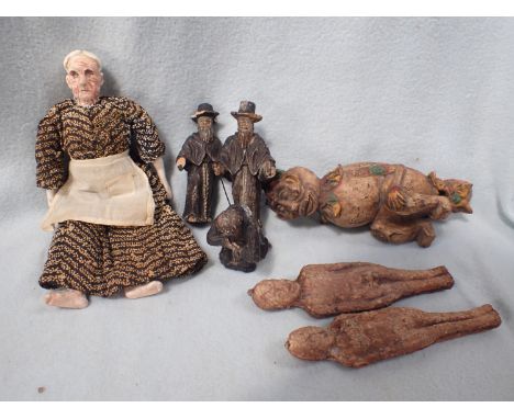 THREE CARVES FIGURES OF JEWISH MEN AND A MONK a doll with ceramic head and limbs, two 'fertility figures', and a carved woode
