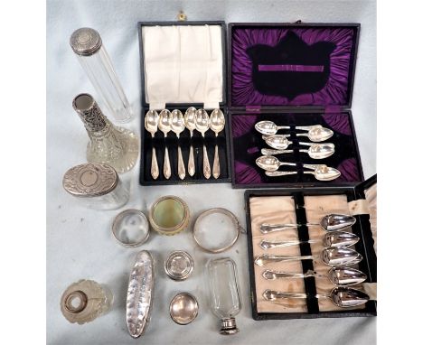 AN ENGRAVED SILVER BANGLE with a collection of silver topped bottles, and three sets of silver plated spoons (one complete) (