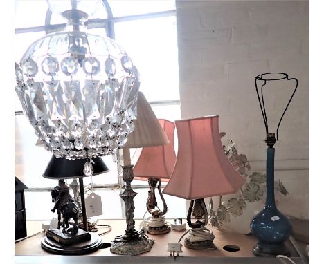 A PAIR OF 0RMOLU TABLE/WALL LAMPS ON A SWING FITTING a spelter lamp in the form of a highwayman (damaged), a chandelier and o