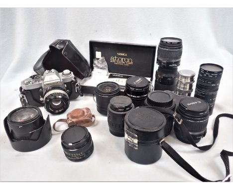 A NIKKORMAT CAMERA and a collection of sundry lenses