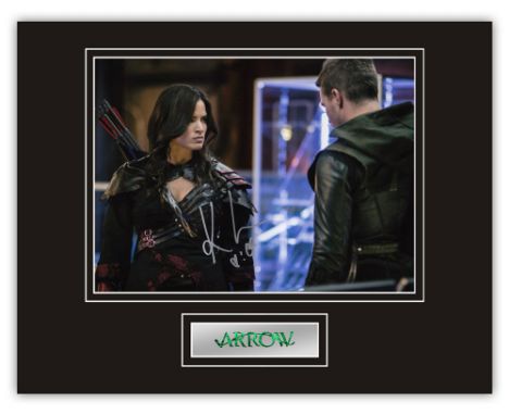 Stunning Display! Arrow Katrina Law hand signed professionally mounted display. This beautiful display consists of a 10"x8" p
