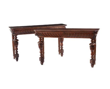 PAIR OF OAK CONSOLE TABLES WITH CARVED APRON AND CARVED TURNED LEGS.HEIGHT: 29 INCHES.WIDTH: 50 INCHES.DEPTH: 14 INCHES.IN GO