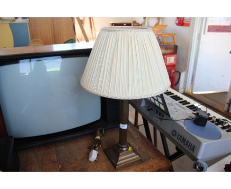 A brass table lamp with shade 