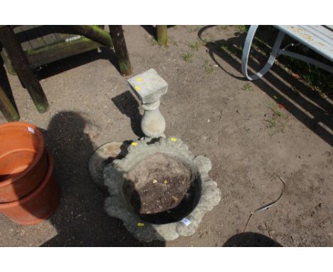 A concrete planter raised on plinth 