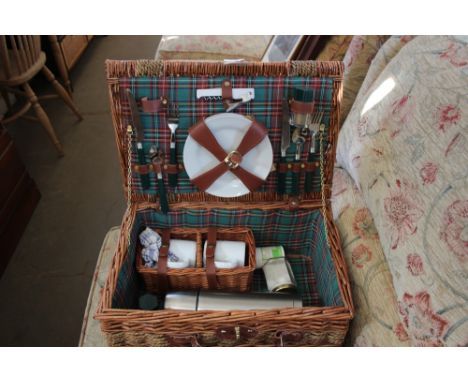 A wicker picnic hamper and contents 