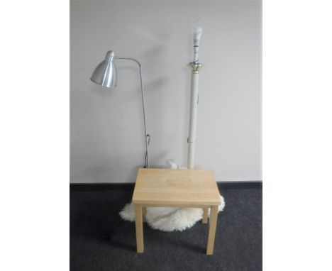 A metal standard lamp together with a metal reading lamp, sheepskin style rug, beech side table 