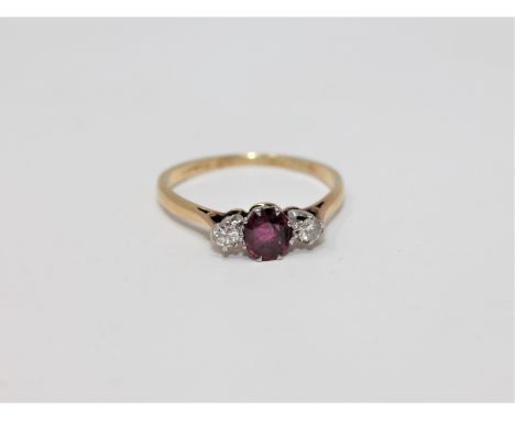 An 18ct gold and platinum set two stone diamond and ruby ring, size Q 1/2.