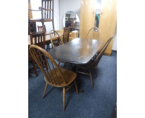 An Ercol refectory dining table together with a set of four high-back dining chairs 