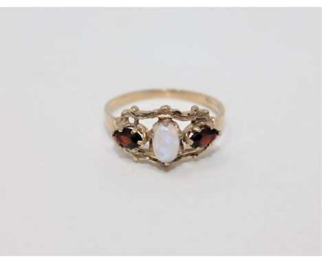 A 9ct gold opal and garnet ring, size N