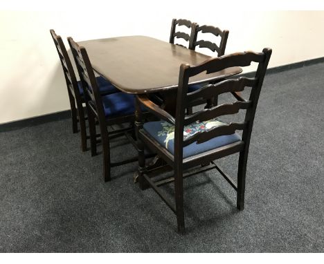 An Ercol refectory dining table and five oak ladder back chairs 