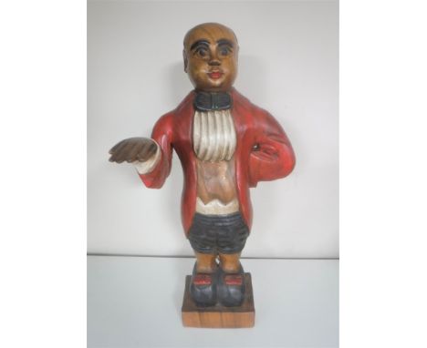 A wooden figure of a butler together with two vintage tennis rackets with stretchers 