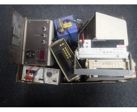 A box of Farnell multimedia DM141 , two Fluke 45 dual display multi meters, 5mm CM20 2BL pulse timer, Comark microprocessor t