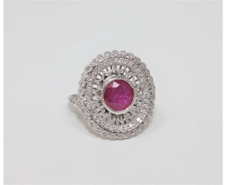 An 18ct white gold ruby and diamond ring, featuring one round cut natural ruby 1.23ct with 70 round brilliant cut diamonds 0.