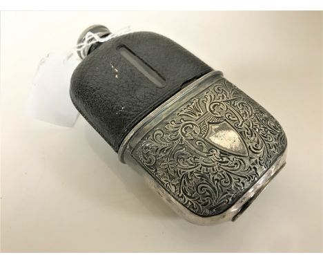 A Victorian hip flask with engraved decoration initialled 'LGM'.