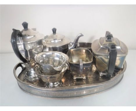 A silver plated gallery tray containing a Sheffield plate four piece tea service and a Cameo three piece plated tea service 