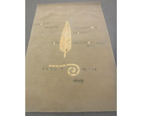 A hand-knotted rug with leaf design on light green ground, 180cm by 270cm