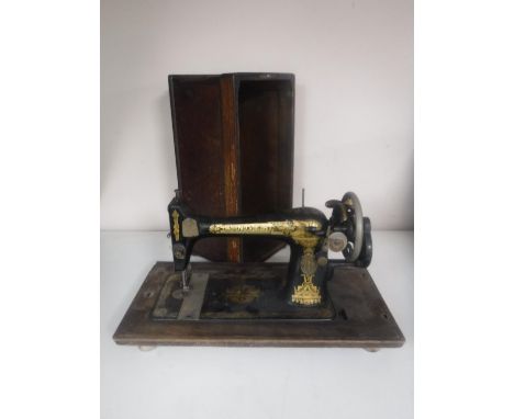 A vintage cased Singer sewing machine together with two poss sticks and tapestry footstool 