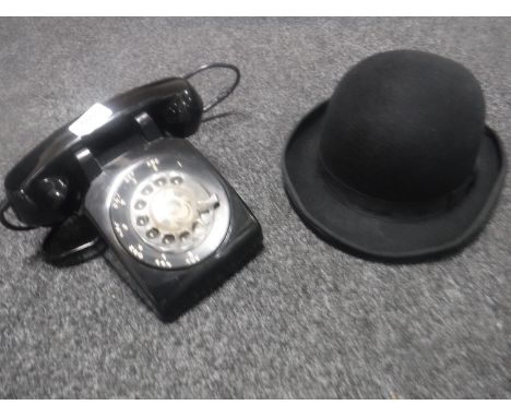 A vintage black telephone together with a bowler hat (with tags), size 6 7/8. (2)