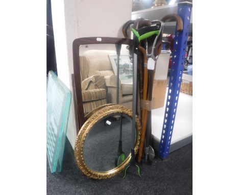 A bundle of walking sticks, shooting stick, circular gilt framed mirror, teak mirror, oil painting etc 