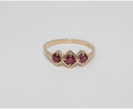 A 9ct gold three stone ruby ring, size O