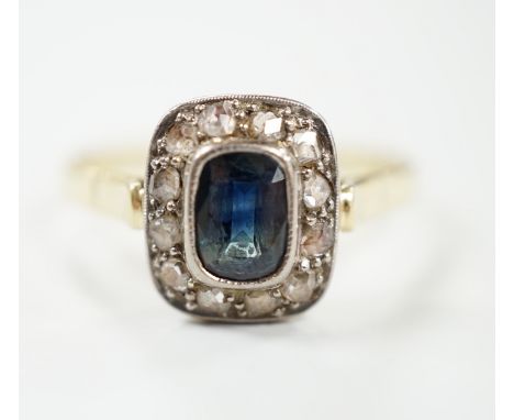 A mid 20th century yellow metal, sapphire and diamond set rectangular cluster ring, size W/X, gross weight 3.7 grams.