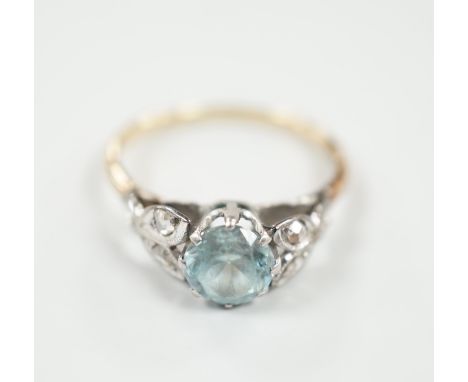 A yellow metal, plat and single stone blue zircon ring, with diamond chip set petal shoulders, size O, gross weight 2.7 grams