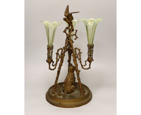 A gilt-metal three-branch epergne with seated dog and three opalescent green glass flutes, 41cm high