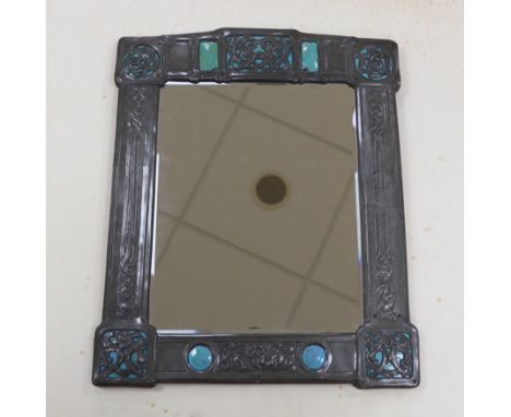 A Miller Brothers Art Nouveau embossed pewter mirror with cabochon turquoise enamel bosses, 48cm high x 39cm wide