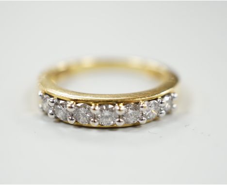 A modern 18ct gold and seven stone diamond set half hoop ring, total carat weight 0.50ct, size J, gross weight 3.4 grams.