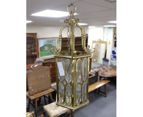 A brass hexagonal four-light hall lantern with bevelled glass panels, 74cm