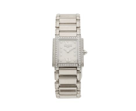 Patek Philippe, an 18ct gold Twenty-4 bracelet watch, factory diamond set case, dial and crown, reference 4908/200G, signed q