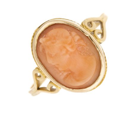 A late 19th century gold, coral cameo single-stone ring, carved to depict a bust in profile, with scrolling shoulders and gro