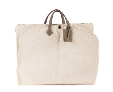 Hermes, a 2009 Victoria garment bag, crafted from beige toile canvas with taupe leather top handles and piping, detachable le