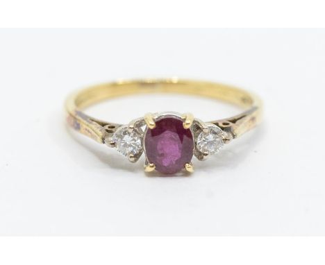 A ruby and diamond three stone ring, comprising an oval ruby to the centre, diamonds set either side, total diamond weight ap