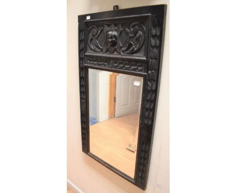 An oak Jacobean style mirror, circa 1900 set with a bevelled glass, 91 x  53cms approxloss of candlestick arms, halfway down 