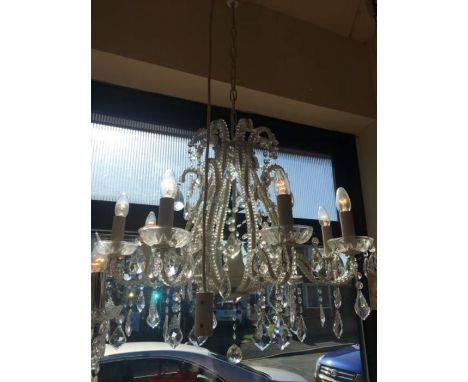 An eight-light crystal and cream frame chandelier, the crystal beads are attached to the central cage and arms, there are eig
