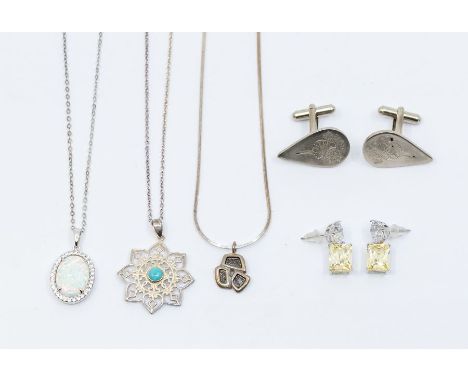 A collection of silver jewellery to include a synthetic opal and white stone pendant on chain, turquoise silver pendant and c